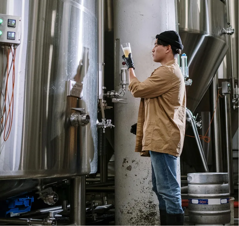 Brewer sampling from a fermentation tank