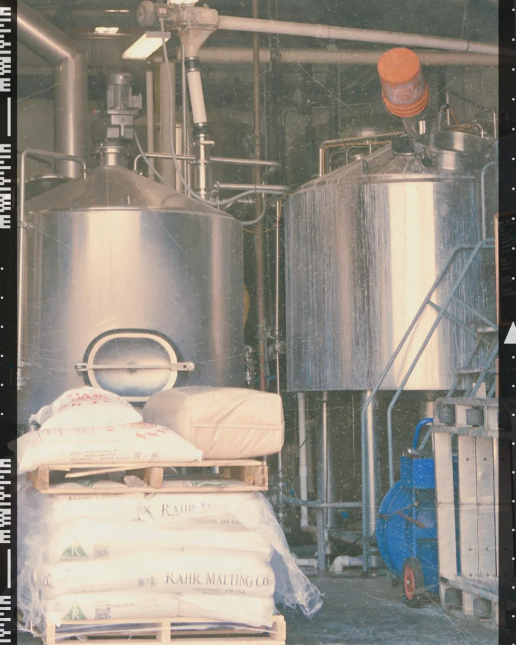 Sacks of grain beside the brew kettles